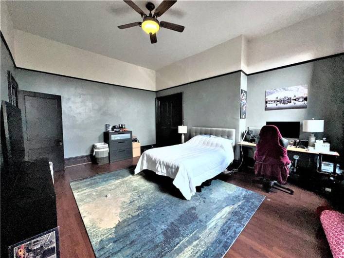 3rd floor bedroom with hardwood floors, high ceilings and private entrance to bathroom area.