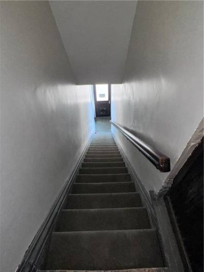View from the 2nd floor stairway to entrance at ground level.