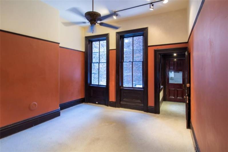 2nd floor rear office with 12 foot ceilings, beautiful woodwork and rear hall to former kitchenette area.