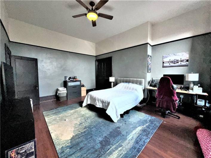 3rd floor apartment bedroom with high ceilings, hardwood floors and private access to bathroom.
