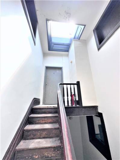 Staircase to 4th floor with skylight to rooftop.
