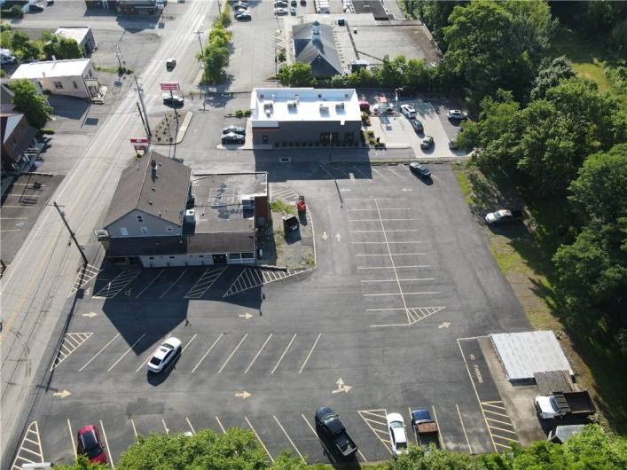 Right side of the property and main entrances for dining and tavern.  Full foundation piece with basement and all utilities in lower right of photo