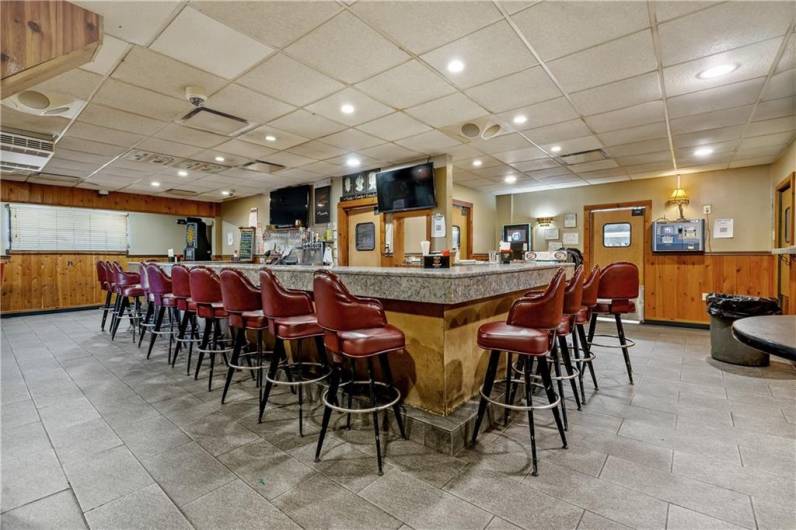 Cuddle up to the beautiful bar and enjoy a drink with family and friends or watch your favorite sports team on the TV's (all furniture and fixtures conveys with sale)