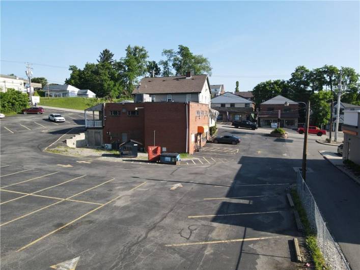 Back of bldg as viewed from left rear corner of property.  Fence on right is left side property border next to Dunkin Donuts.