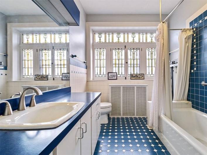 Hall bathroom with stained and leaded glass.