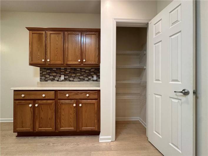 Oak cabinetry, ceramic backsplash and pantry in Kitchen.