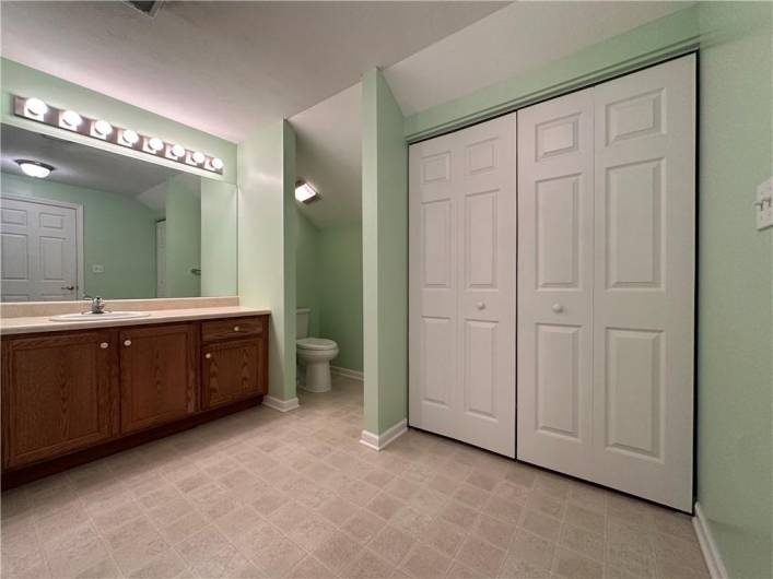 2nd Floor Owner's Suite Bathroom has tub/shower, large oak vanity, walk-in closet, plus double closet.