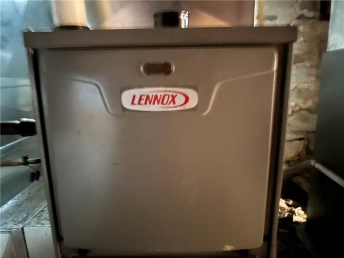 There are 2 Lennox furnaces side by side in the basement.