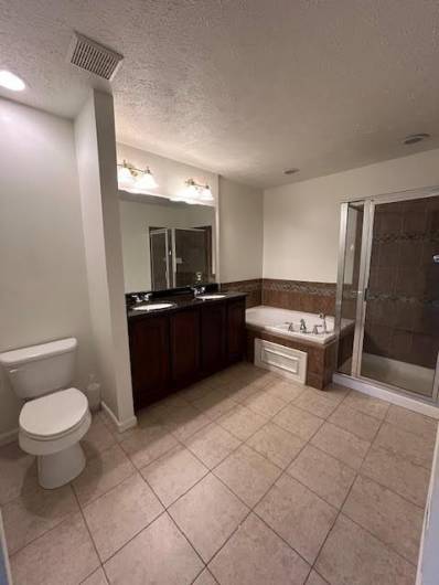 En suite bathroom with tub and walk in shower.