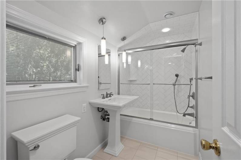 This gorgeous updated bathroom with tile floor and bath is ocated on the second floor.