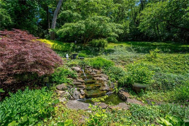 You will love the peaceful waterfall and pond in the back yard.