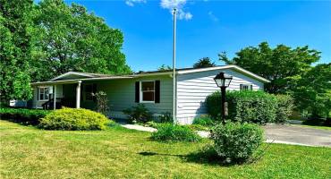 Welcome to 136 York Dr!  The covered front patio is a comfortable place to enjoy the pretty outdoor setting.