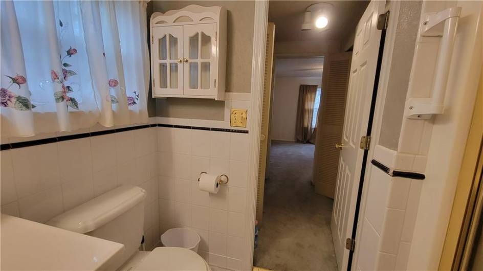 Looking back towards the primary bedroom from bathroom #1.  The hallway in between is lined with closets on each side!