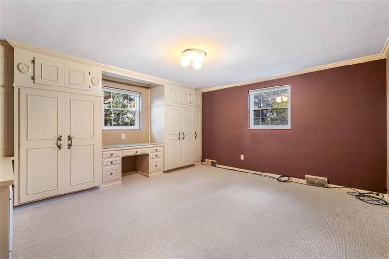 Large carpeted bedroom used as office.