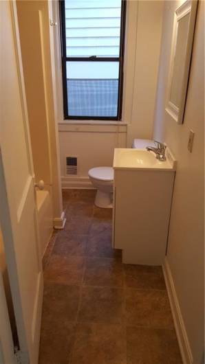 Newer vanity, mirror and commode.