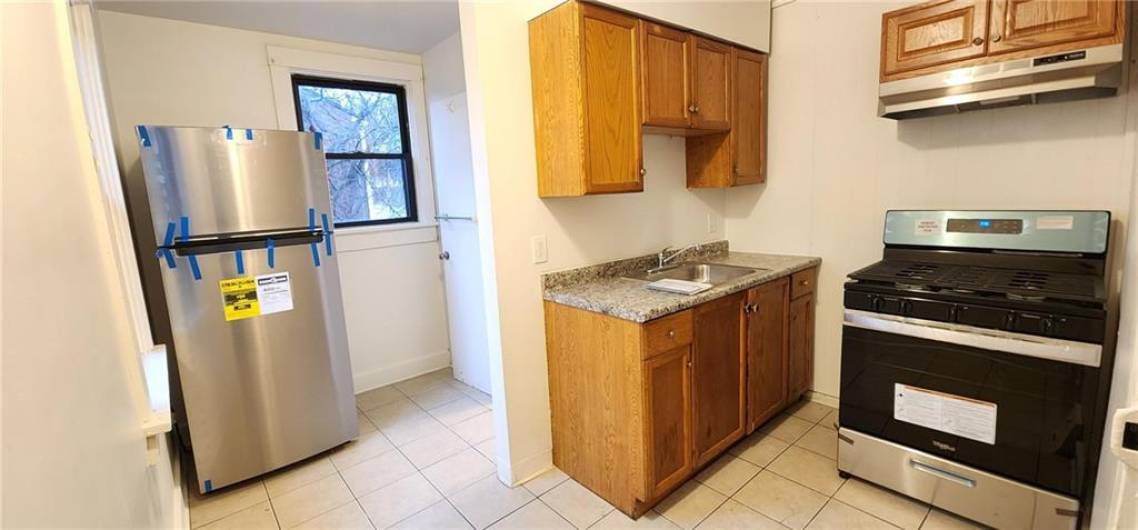 New Stainless Steel Refrigerator, range & hood fan. New countertop, sink & faucet.