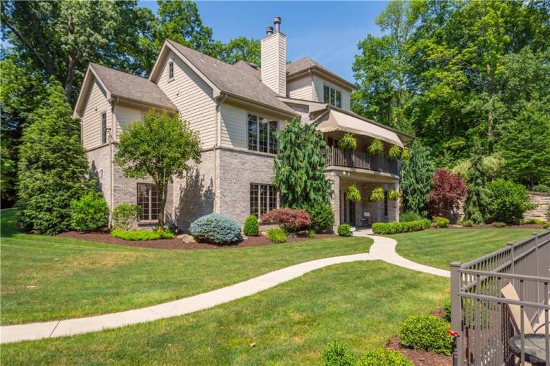 Paved walkways lead to the detached structure or inground pool.