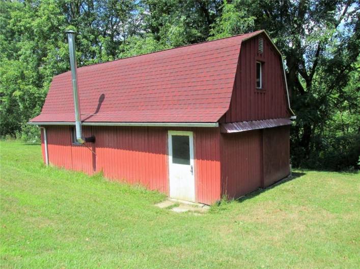 Two story storage barn is quite spacious and has wood burner, too.