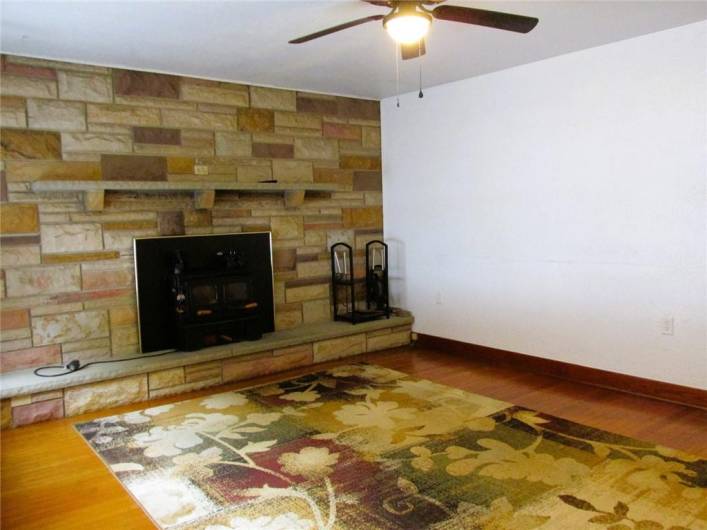 Gorgeous stone wall and mantle with wood burning fireplace makes a wonderful focal piece in the Living Room.