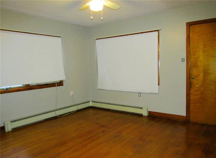 Main floor bedroom has original hardwood flooring...
