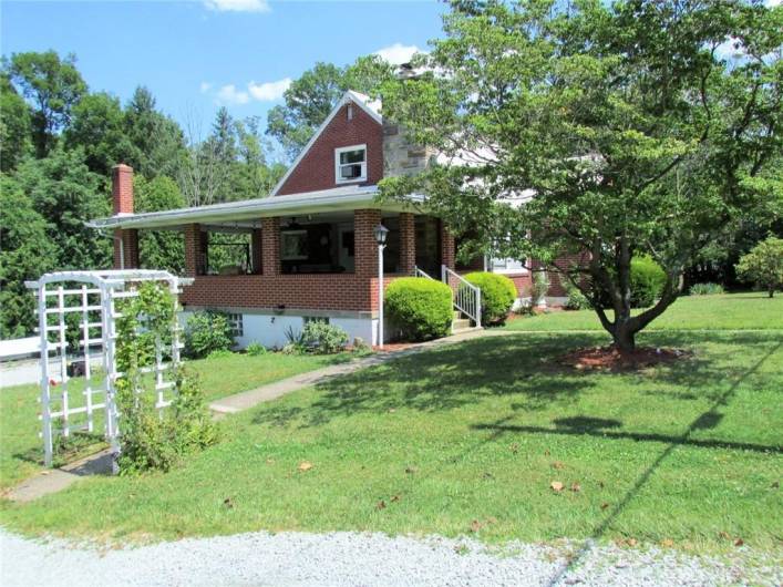 This Charming Brick Cape Cod has a spacious covered side entrance...
