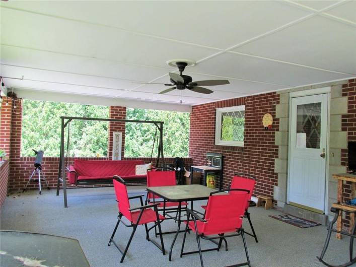 The spacious covered side porch is roomy enough for BBQs and more!