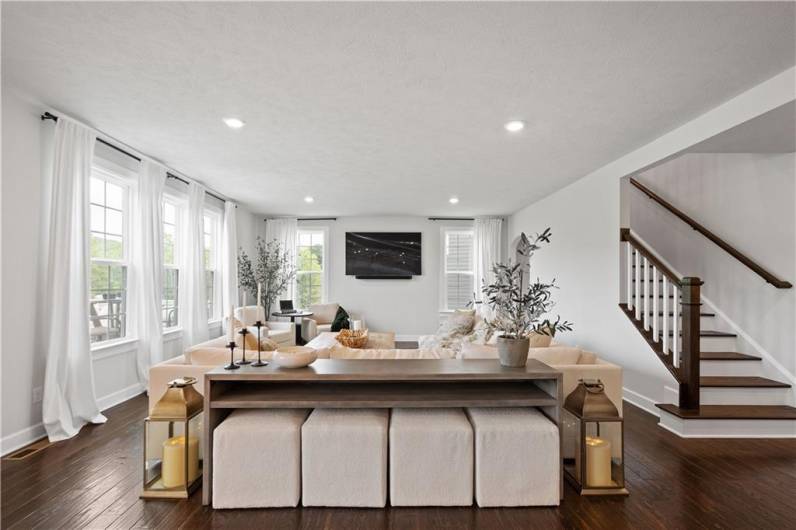 Large and open Family Room anchored by walls of windows.