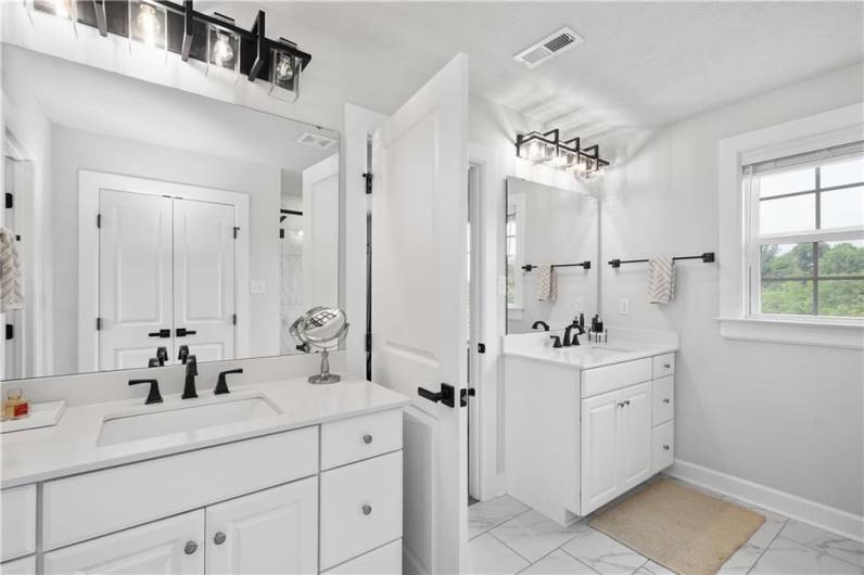 Owner's Suite w/ 2 closets, dual vanities & large tiled shower.