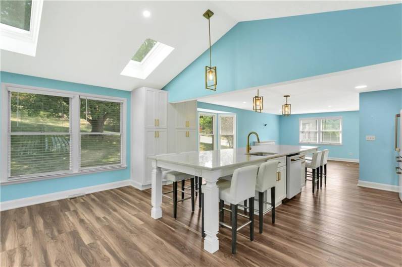 Skylights in the cathedral ceiling enhance the beauty of this kitchen.