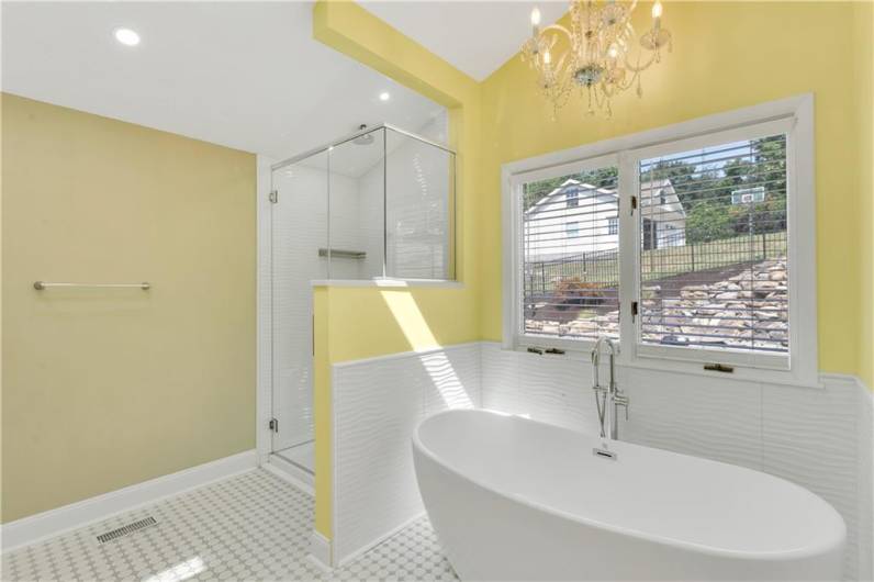 Stylish en suite withsoaking tub, walk in shower and gorgeous chandelier.