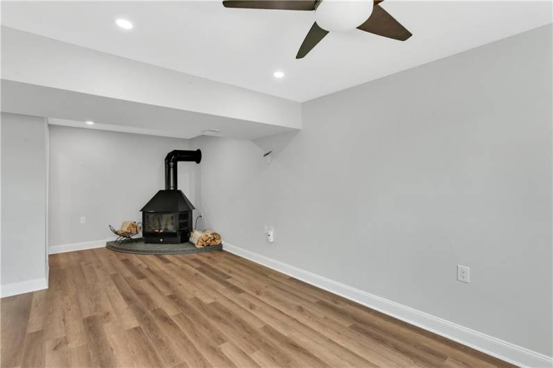 Cozy wood burning fireplace in finished lower level.