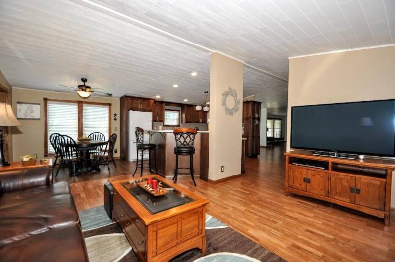 This photo shows, family room, kitchen, dining.  Look at the vaulted ceiling. All new.