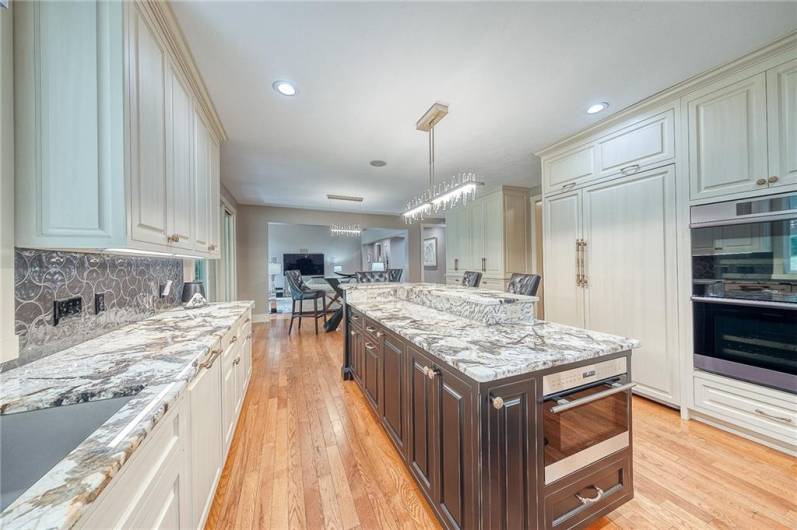 Custom maple cabinets with Edgar Berebi knobs and pulls, Top-of-the-line appliances, Wolf Sub-Zero, Wolf Induction Cooktop, Dacor double oven w/steamer, 2 Bosch dishwashers, Wolf Speed Oven/Microwave. Hardwood floors, large pantry, sliding door to covered back patio