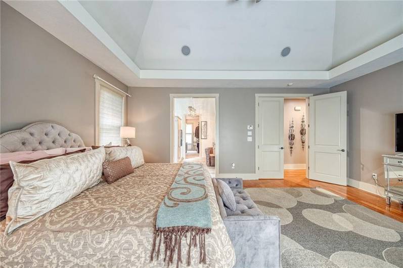 First floor primary suite has vaulted ceiling, hardwood floors, sliding door to added deck and built-in hot tub.  The   primary closet offers built-ins