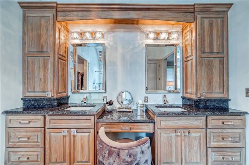 Primary bathroom updated with custom maple cabinets, dual rain head shower system, heated floor.  Enchanted glass custom inserts in primary bath windows.