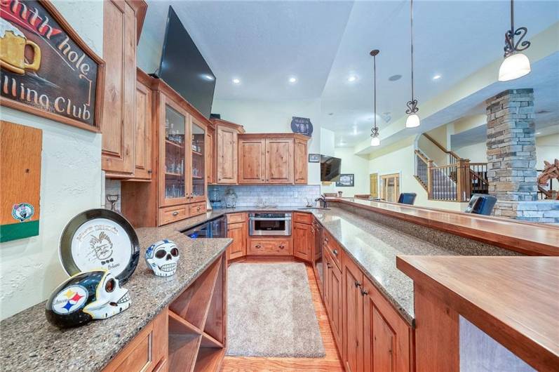 Built in bar lower level game room.  Beverage center, microwave oven and dishwasher behind bar.  Manufactured hardwood throughout game room