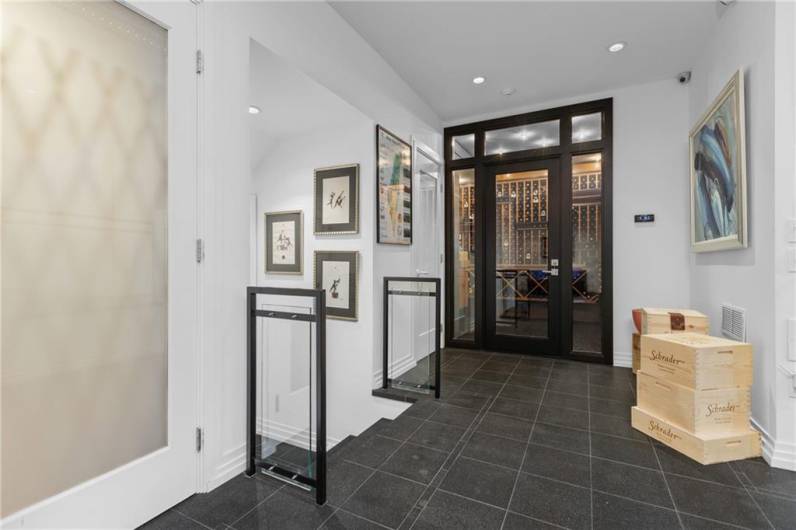 Note one of the elevators to the left, wine room straight ahead