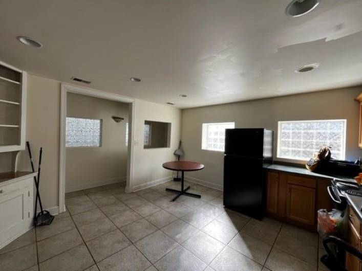 Eat in area of the kitchen and a view of the hallway/mud room area that leads to the back door, deck and parking lot.