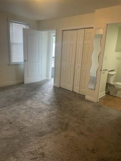 Alternate view of lower level bedroom.  Here you can see the entrance to the outdoor deck is outside of the bedroom door.
