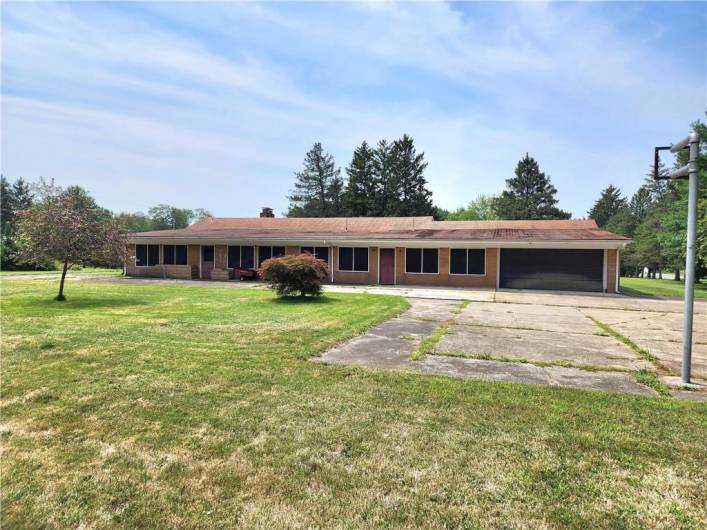 Back Showing Garage, Covered patio and Massive parking area