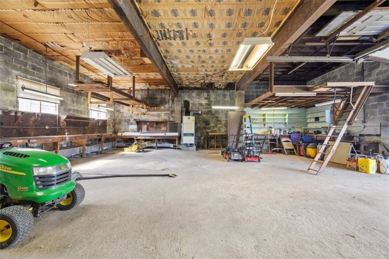 HUGE 37.5'x36' main building garage with 11' ceiling. This space was used as a place to work on/store cars. It can easily house 4 cars - probably more.