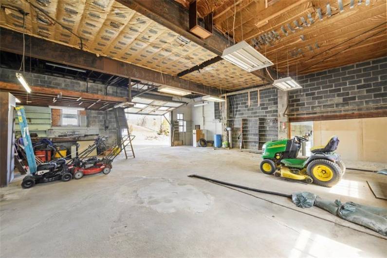 Alternate view of main building garage from the far corner, looking toward the garage door. Ceiling height is potentially high enough for a lift.