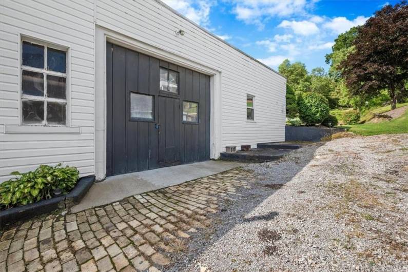 Side of main building showing garage door. Door is 11.5'w x 9'h.
