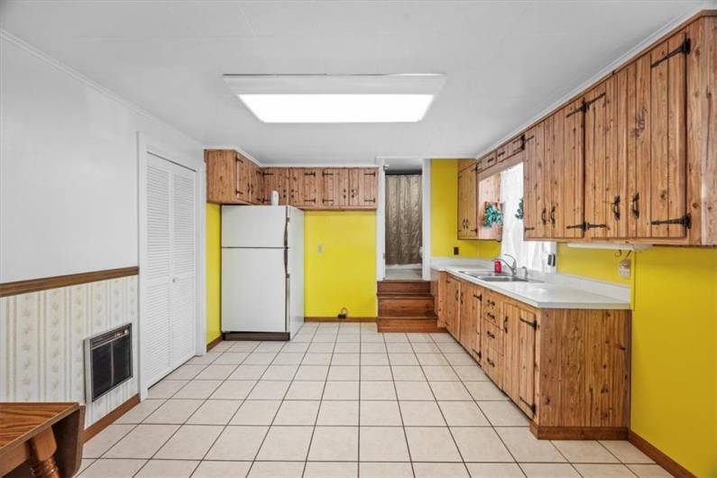 Enter the 2nd floor apartment of the main building into the 13x11' kitchen. The full bath is up the stairs at the far end. Laundry is through the doors on the left wall.