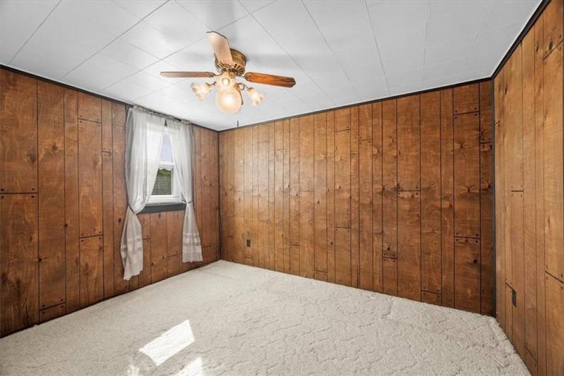 Bedroom 1 in the 2nd floor apartment is 12x9'. There is hardwood flooring under this carpet.