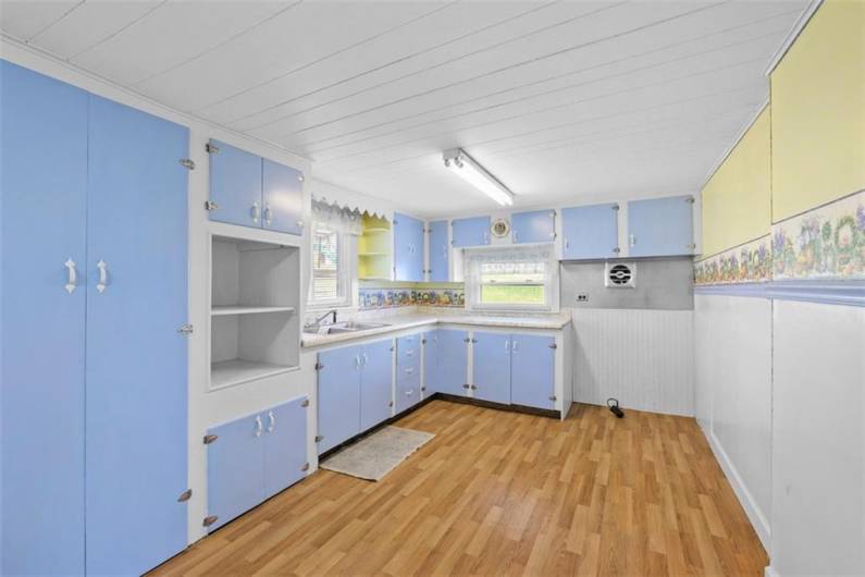 The kitchen of the small house is 20'x10'. New vinyl flooring has just been installed.