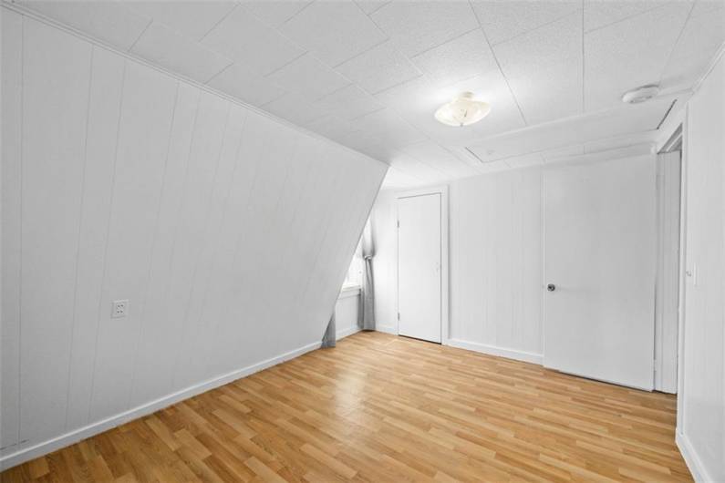Alternate view of the bedroom situated off of the living room of the small house.
