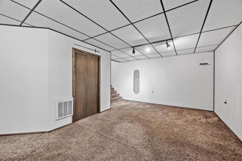 The back office in the lower level commercial space is 21x12'. The stairs lead to a half bathroom.