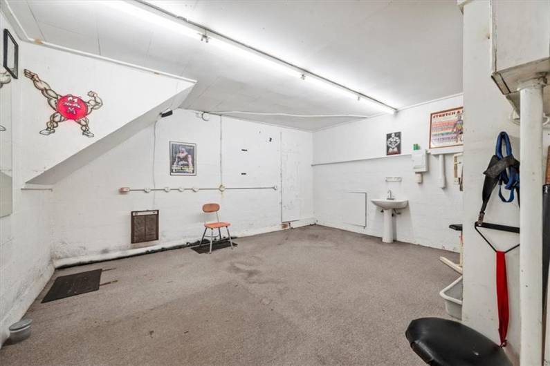 This 17x14' room in lower level commercial space has been used as a repair shop. It could be a 3rd office, storage, work shop, repair shop, anything really.