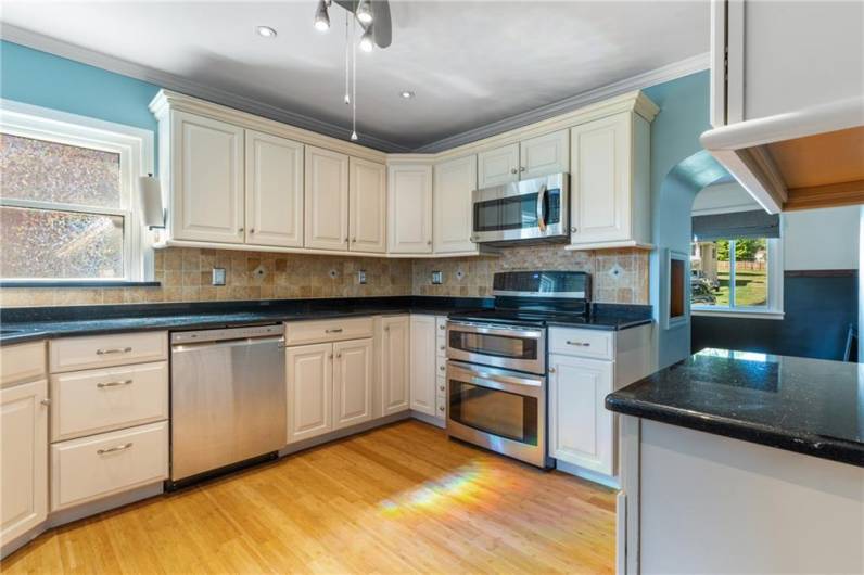 Expansive granite countertops offer ample space for meal prep and cooking convenience.